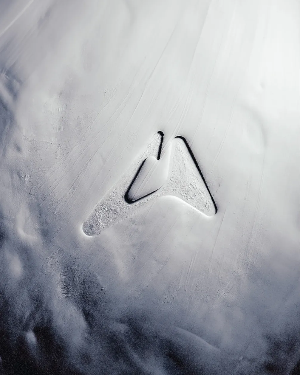 Artefact logo pressed into a soft white textured surface, brand visual by Junca Studio